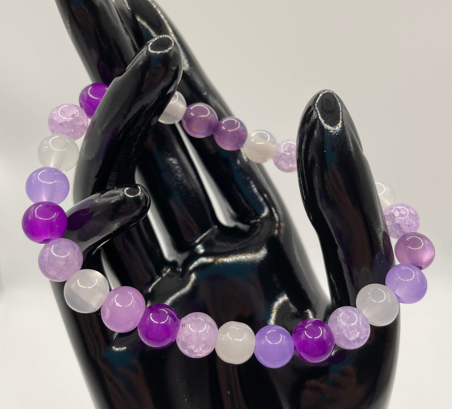 Multi purple and white hued 8mm glass bead stretch bracelet. 6.75”