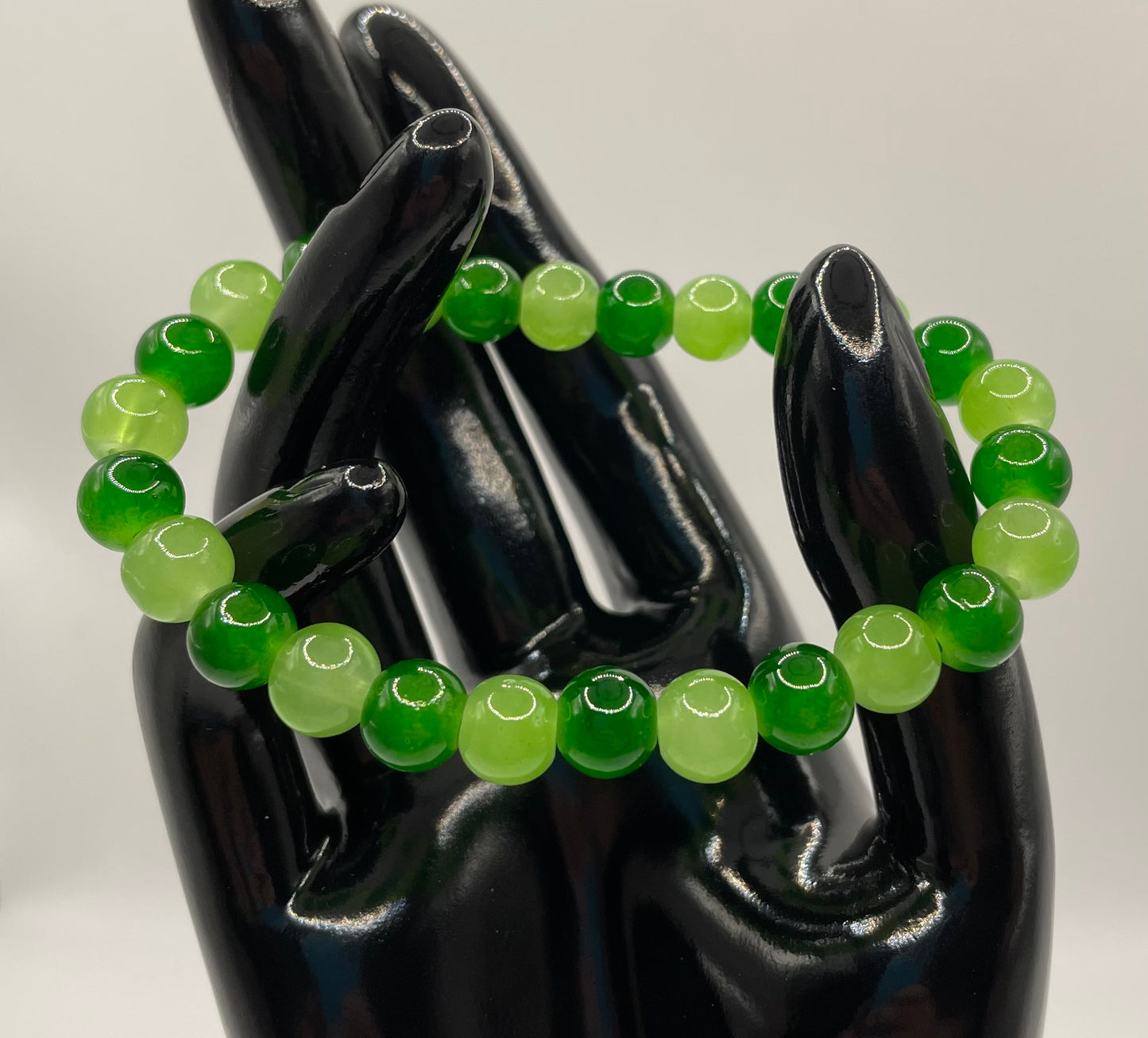 Multi hued green 8mm glass bead bracelet. 6.5”