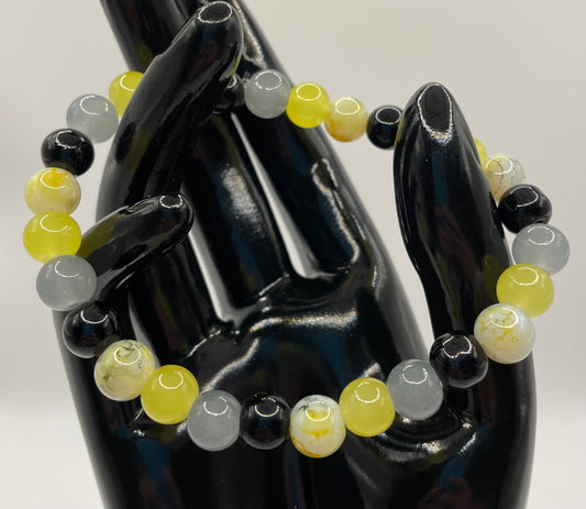 Black, yellow, gray, and white multi 8mm glass bead stretch bracelet. 7”