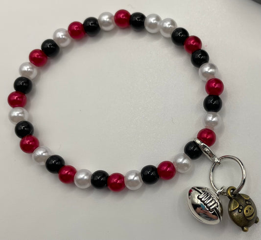 6mm black red white faux pearl stretch bracelet with football charms. 6”