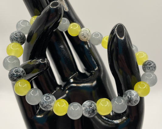 Black, gray, and yellow 8mm glass bead stretch bracelet. 6.75”