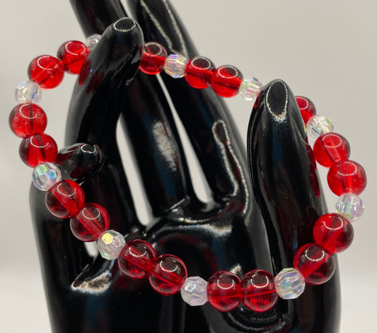 Red glass 8mm bead with 6mm faceted clear beads for sparkle. Bracelet 6.75”