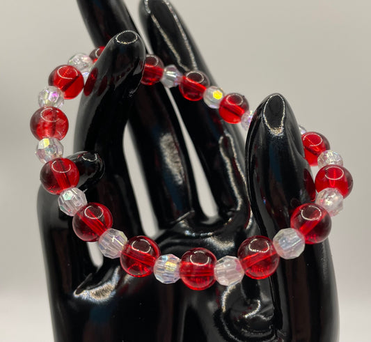 Red 8mm glass beads with 6mm faceted clear beads. Stretch Bracelet  6.5”