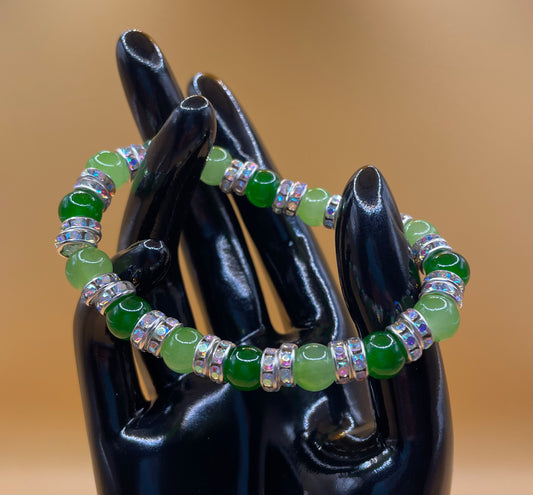 Mixed green 8mm glass bead stretch bracelet with rhinestone spacers. 6.5”